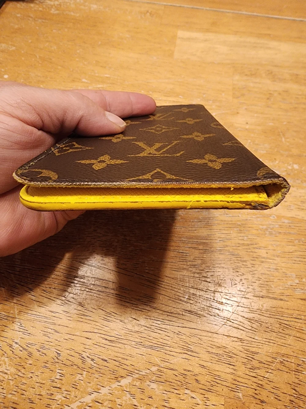 Louis Vuitton Monogram iPhone Folio Case crafted in the brand's signature brown